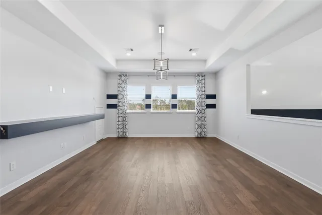 a view of a kitchen with a sink dishwasher a refrigerator and wooden floor