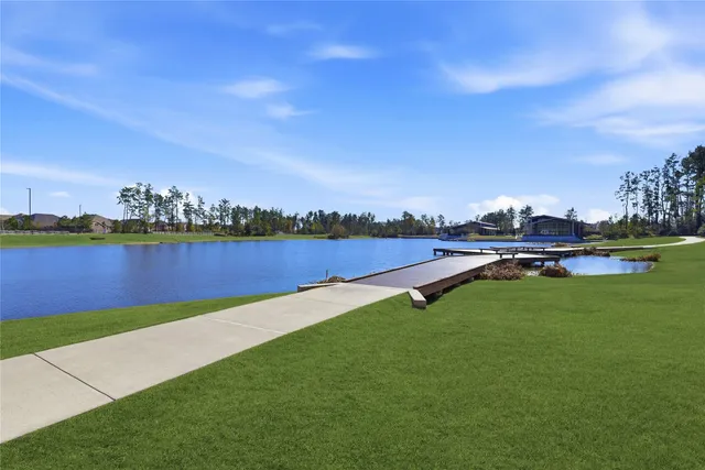 a view of a lake with houses in the back