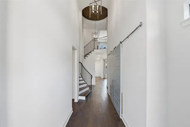 a view of entryway and hall with wooden floor
