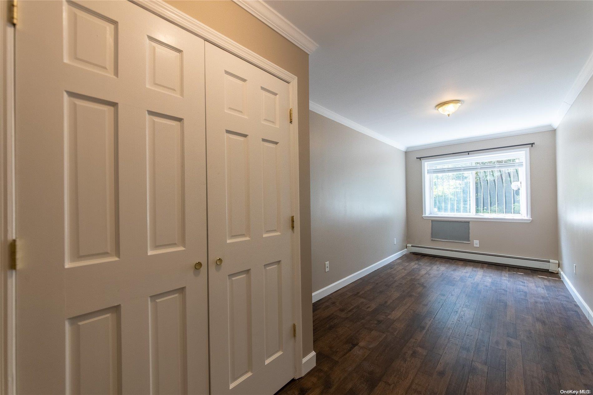 334 Lincoln Road Brooklyn, NY 11225 - Photo 1 of 11 a view of an empty room with wooden floor and a window