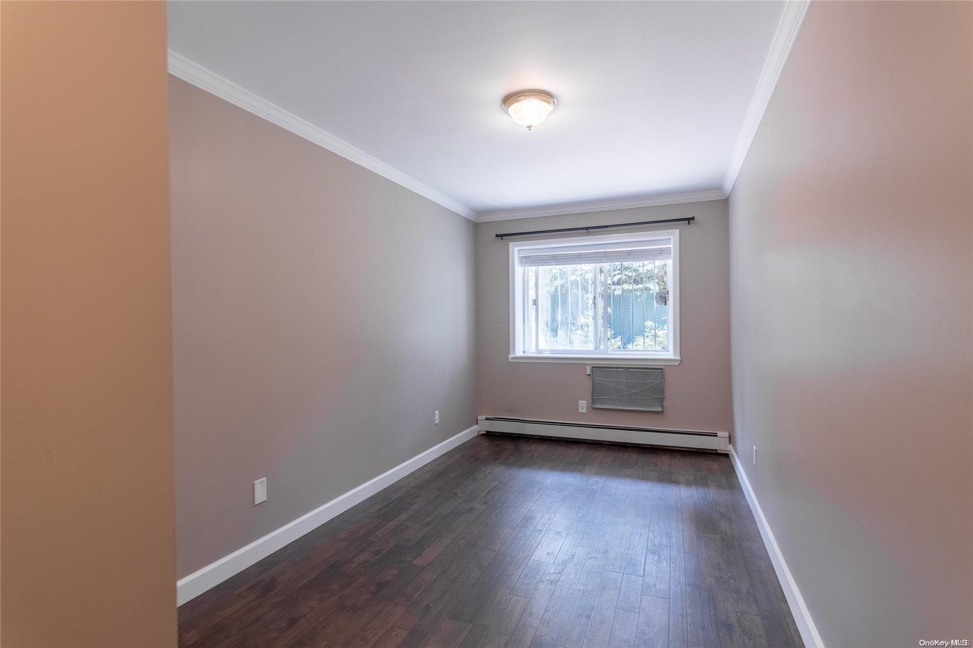 334 Lincoln Road Brooklyn, NY 11225 - Photo 4 of 11 an empty room with wooden floor and windows