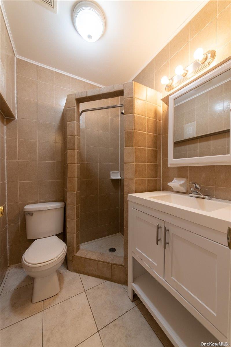 334 Lincoln Road Brooklyn, NY 11225 - Photo 5 of 11 a bathroom with a sink toilet and shower