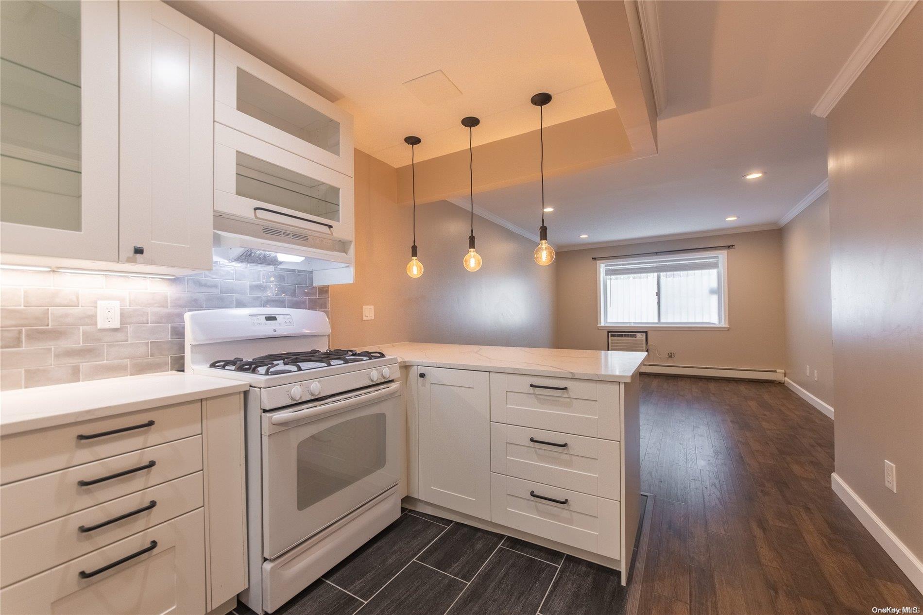 334 Lincoln Road Brooklyn, NY 11225 - Photo 7 of 11 a kitchen with a stove oven and white cabinets