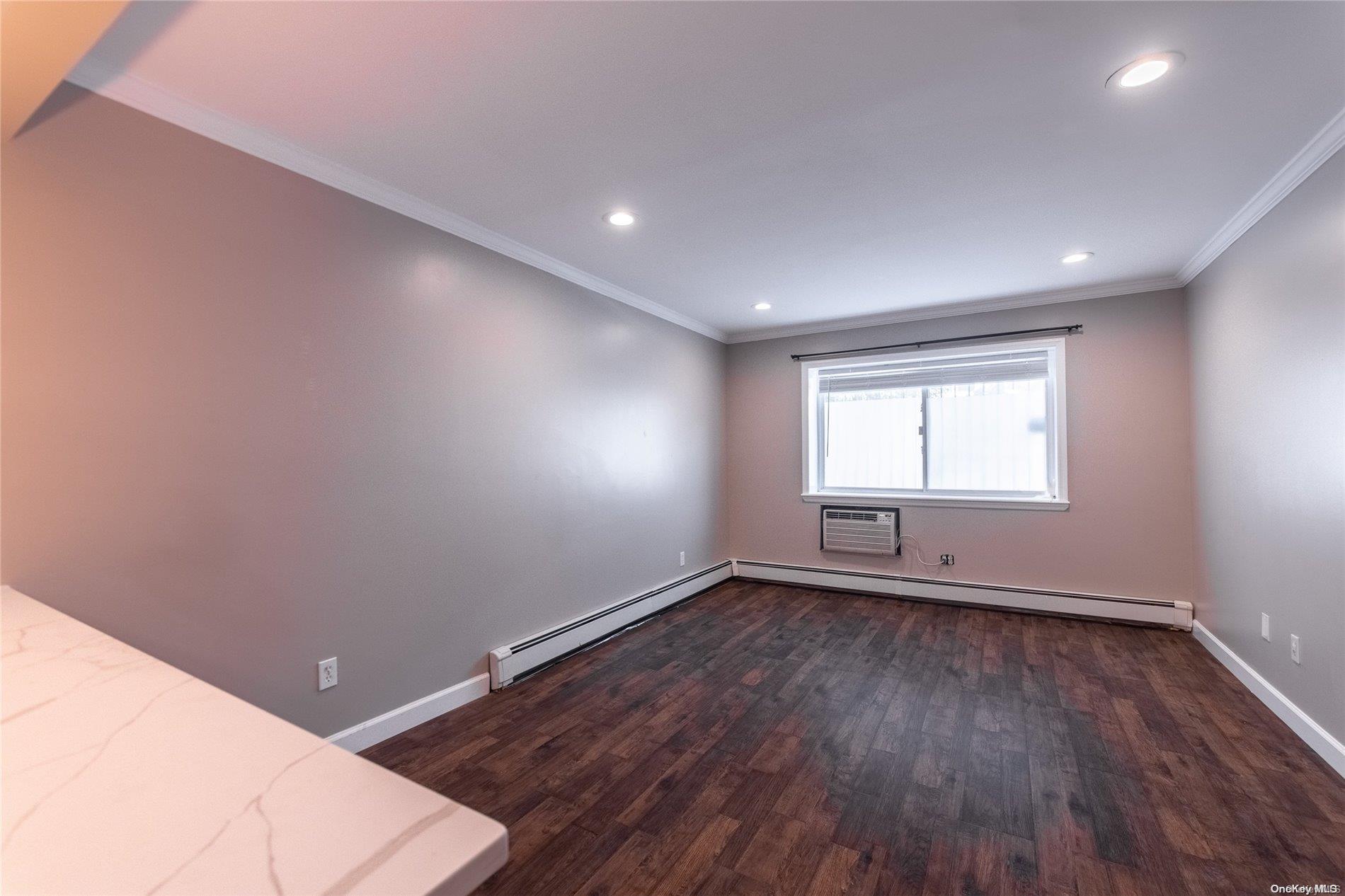 334 Lincoln Road Brooklyn, NY 11225 - Photo 8 of 11 a view of an empty room with wooden floor and a window