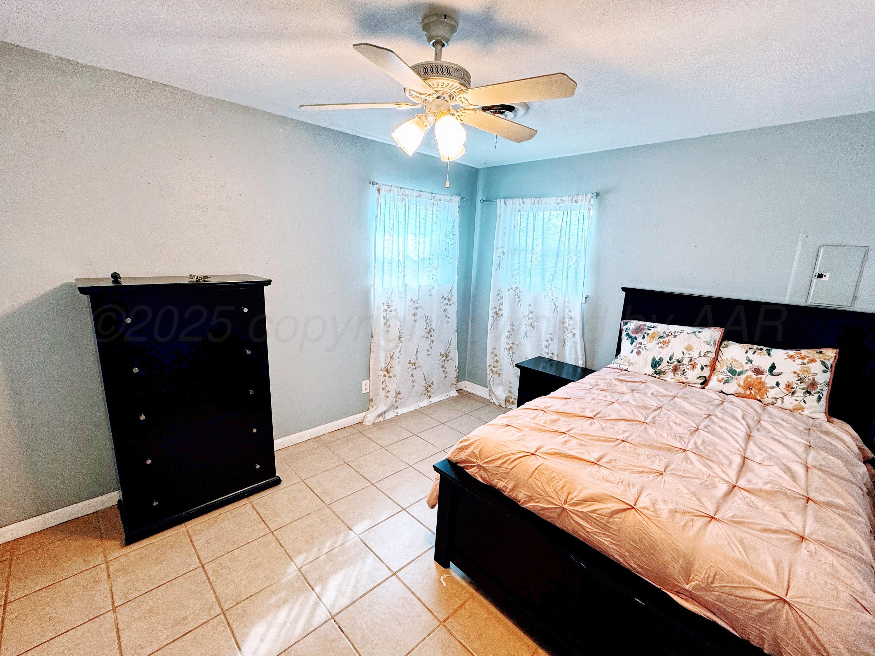 2006 Drake Drive Perryton, TX 79070 - Photo 11 of 17 a bedroom with a bed and a dresser