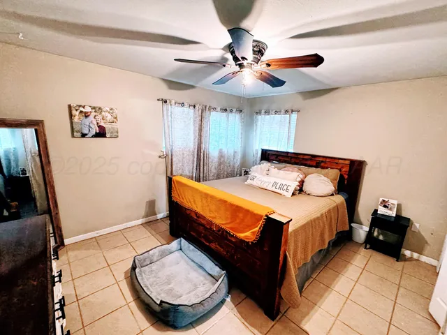 a bedroom with a bed and a mirror on the dresser