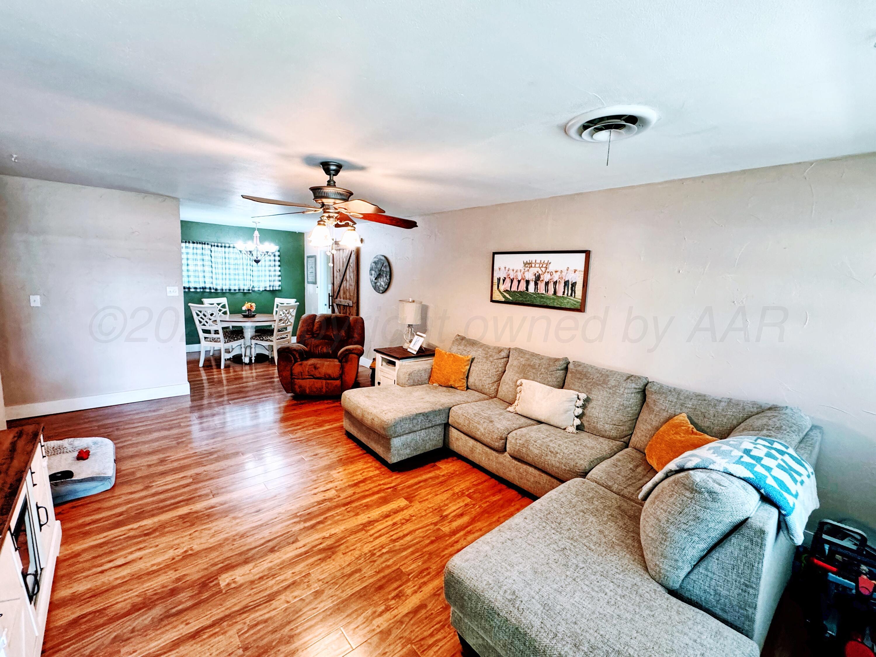 2006 Drake Drive Perryton, TX 79070 - Photo 2 of 17 a living room with furniture and a chandelier