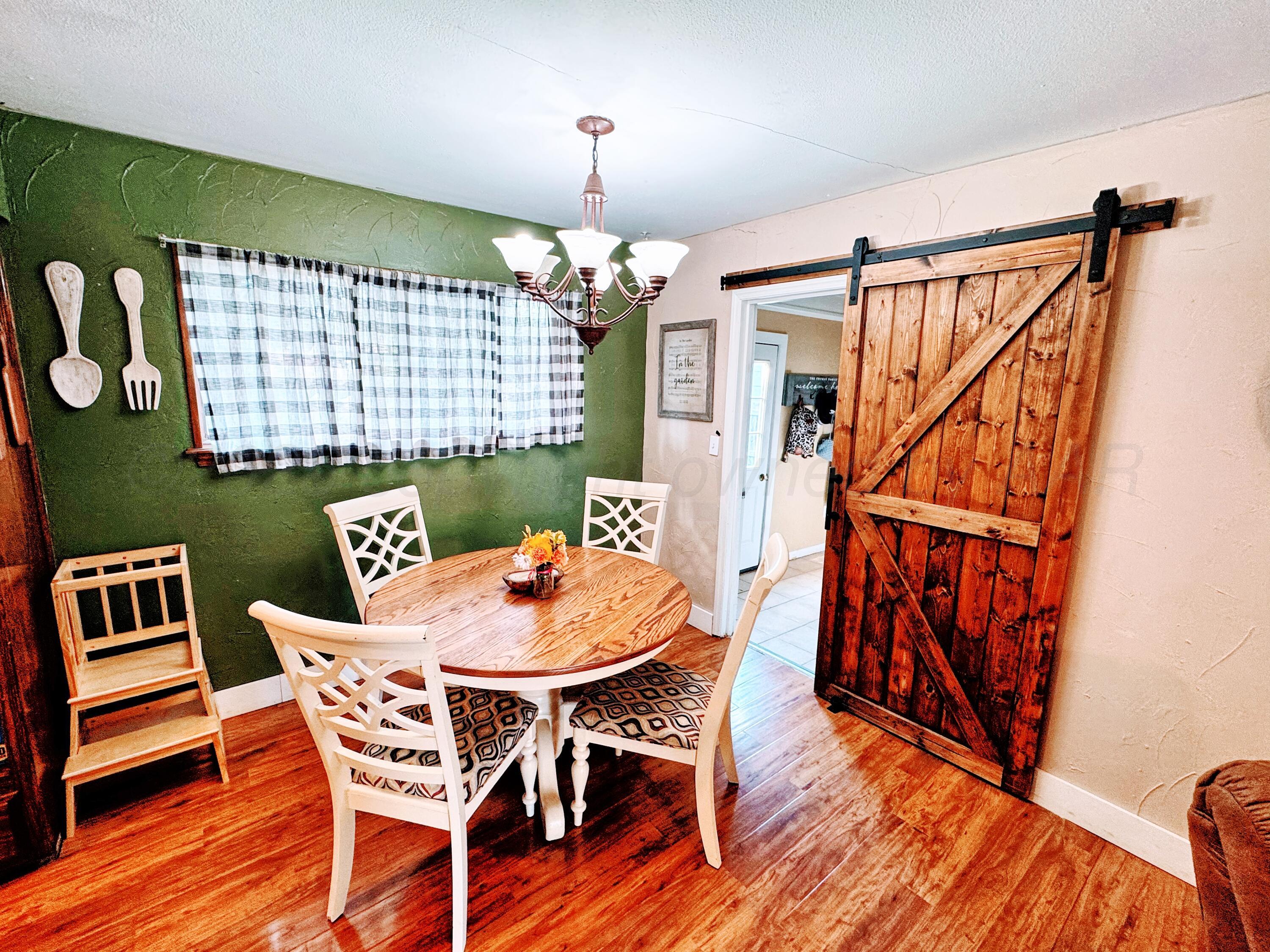 2006 Drake Drive Perryton, TX 79070 - Photo 3 of 17 a view of a dining room with furniture window and wooden floor