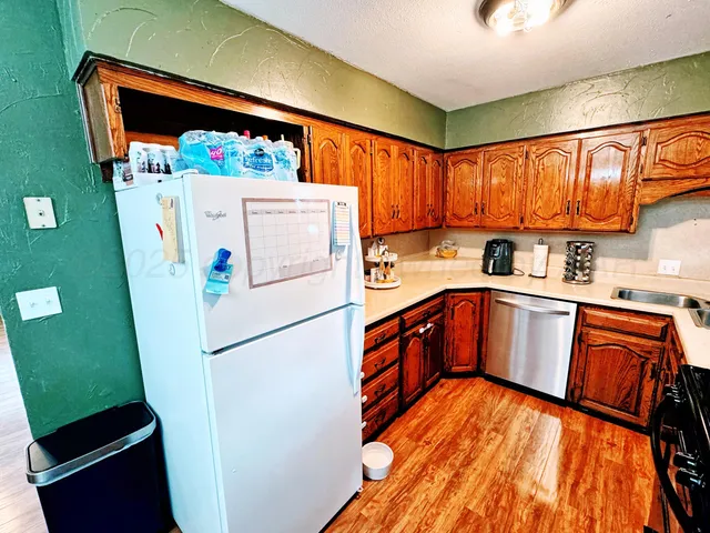 a white refrigerator freezer sitting inside of a kitchen