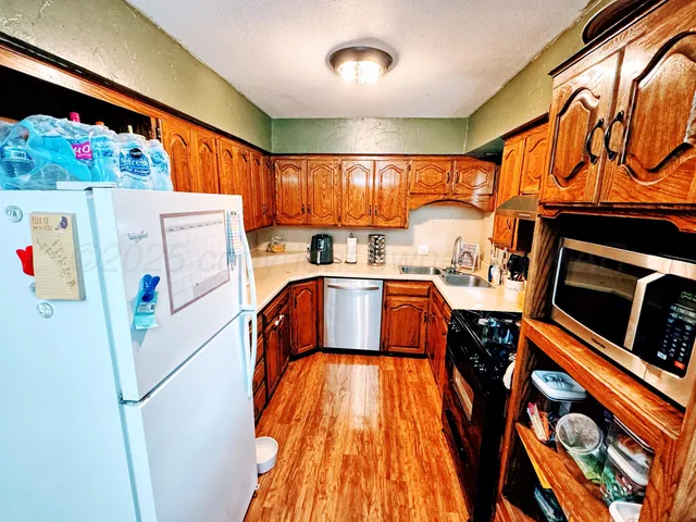 a kitchen with a refrigerator and a stove