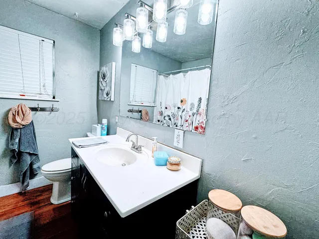 a bathroom with a sink toilet and a mirror