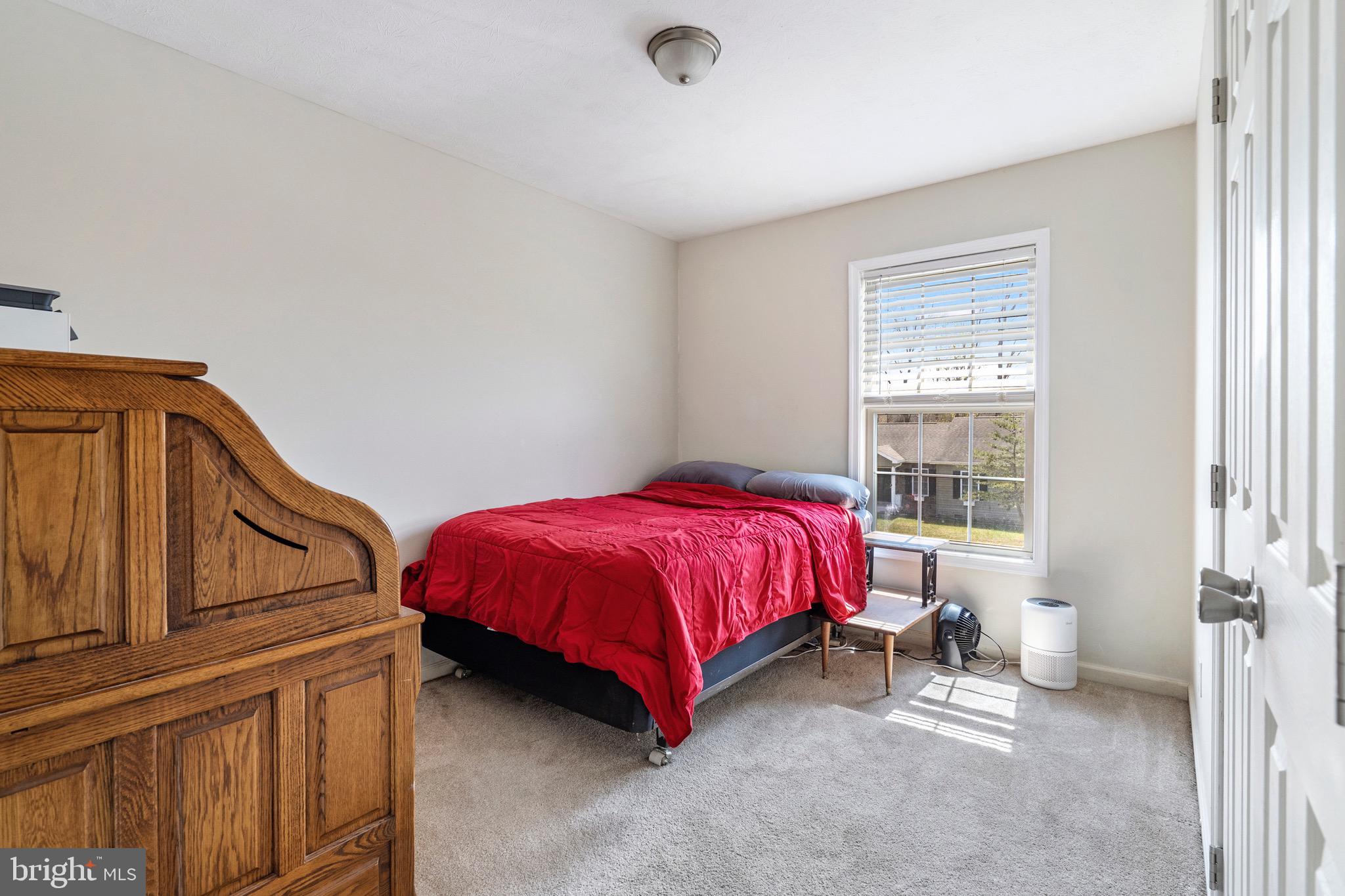183 Basin Drive Inwood, WV 25428 - Photo 14 of 27 a spacious bedroom with a bed and a window