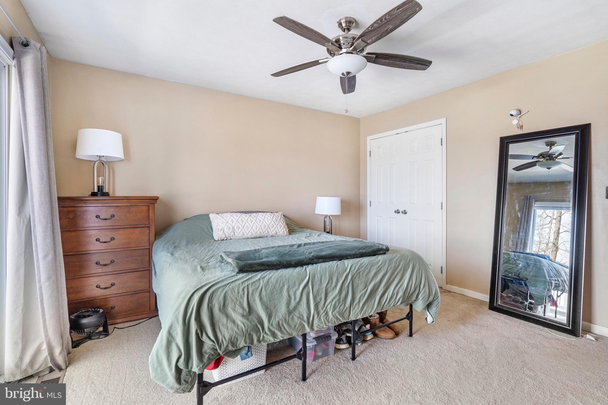 183 Basin Drive Inwood, WV 25428 - Photo 17 of 27 a bedroom with a bed and a chandelier