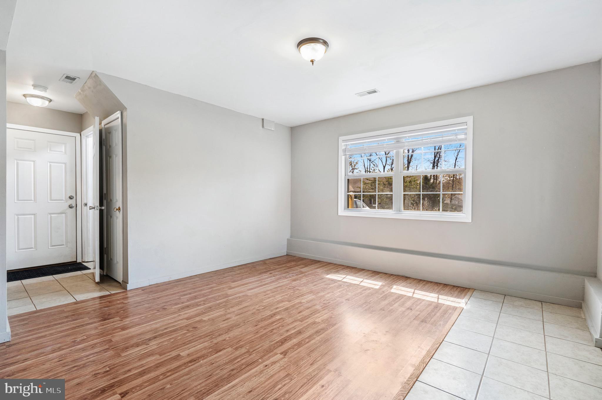 183 Basin Drive Inwood, WV 25428 - Photo 19 of 27 an empty room with wooden floor and windows