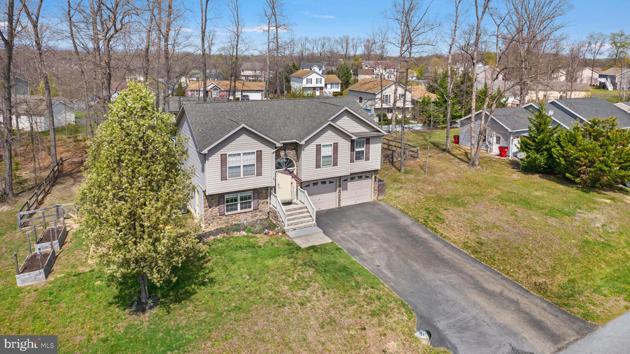 183 Basin Drive Inwood, WV 25428 - Photo 26 of 27 a view of a house with a yard and potted plants