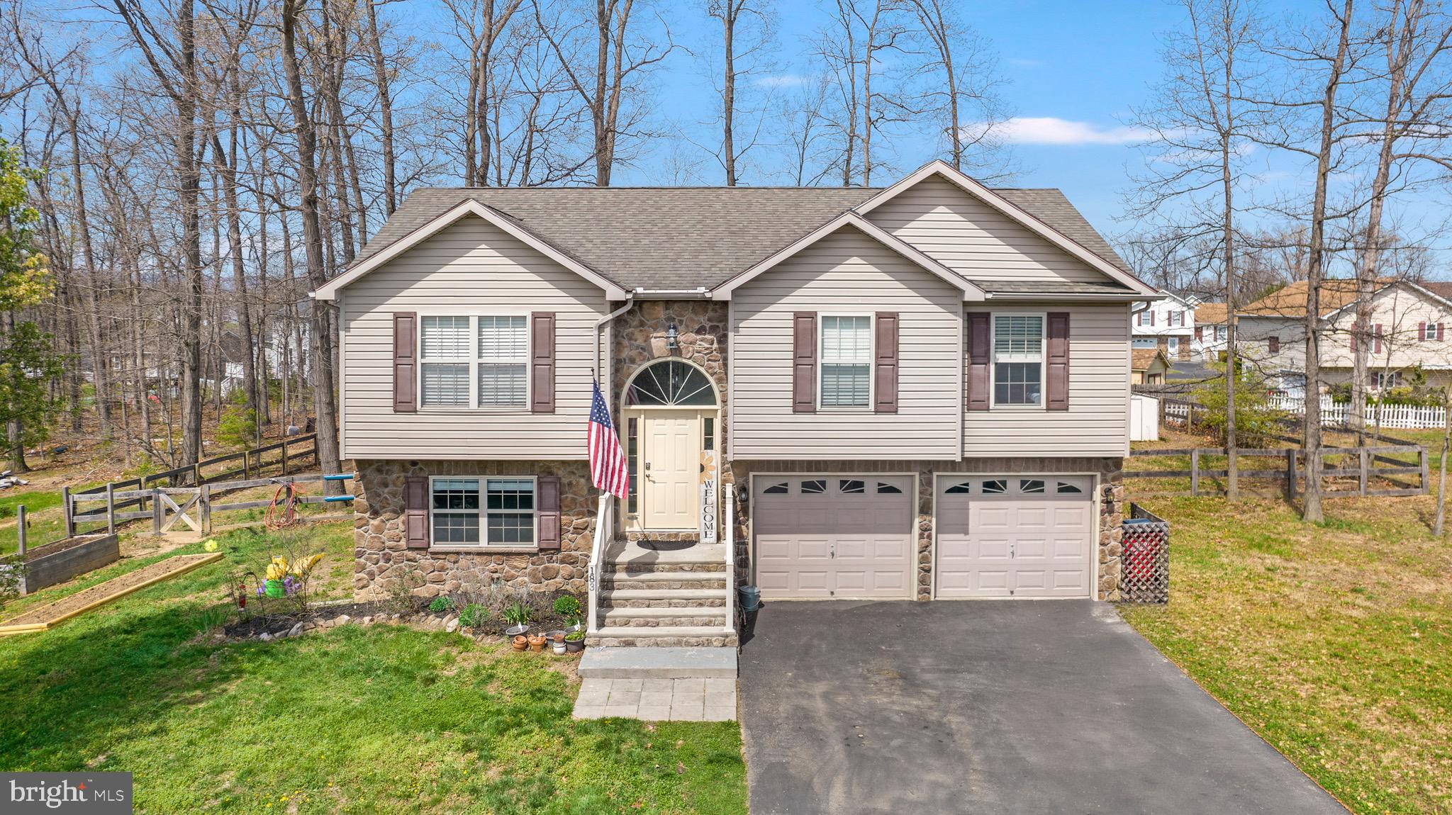 183 Basin Drive Inwood, WV 25428 - Photo 27 of 27 a front view of a house with a yard and garage