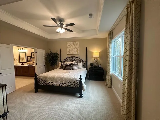 a bedroom with a bed and ceiling fan