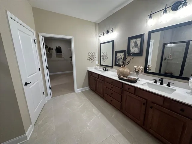 a bathroom with a double vanity sink double vanity and mirror