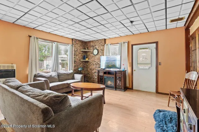 a living room with furniture a large window with workspace