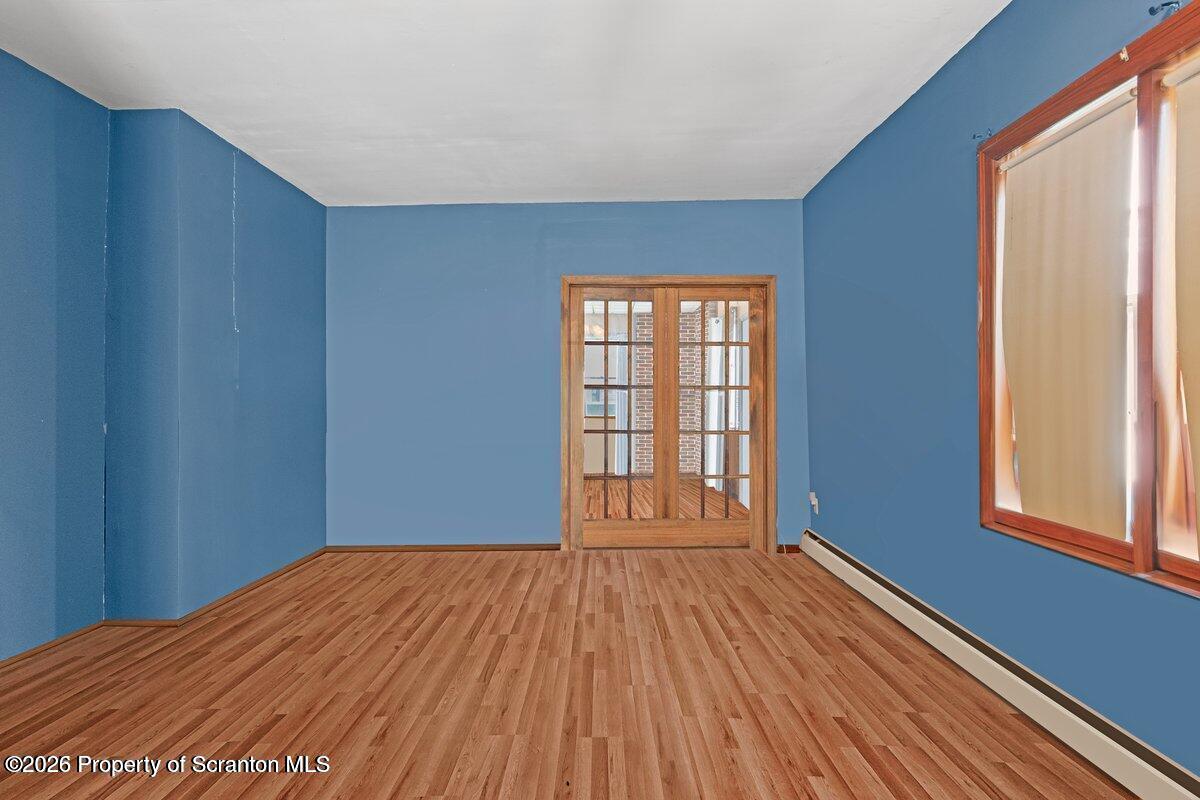 1411 Watson Street Scranton, PA 18504 - Photo 17 of 26 a view of empty room with wooden floor and fan