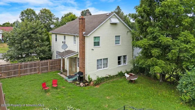 a view of an house with backyard space and garden