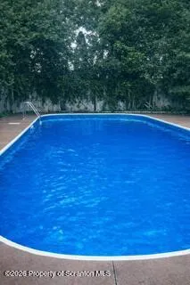 a view of a room with an empty space and wooden floor
