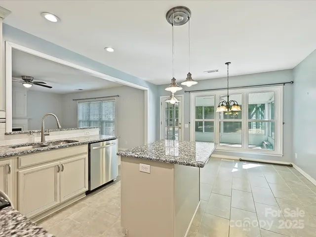 a kitchen with white cabinets and appliances