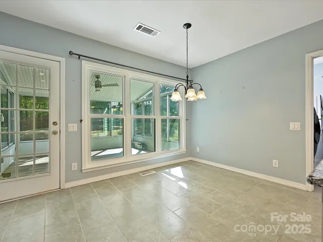 a kitchen with stainless steel appliances a stove a refrigerator a sink a microwave oven with cabinets and wooden floor