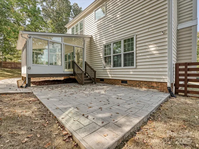 a view of backyard with a large tree