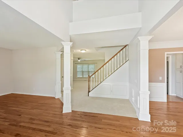 a view of an entryway with wooden floor and door