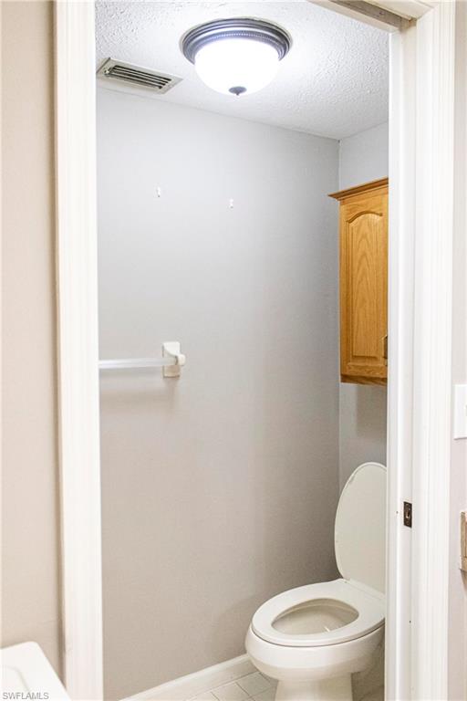 707 Hoover Dike Road Clewiston, FL 33440 - Photo 17 of 39 a white toilet sitting next to a bathroom sink