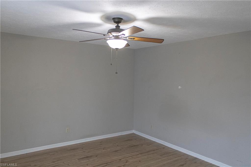 707 Hoover Dike Road Clewiston, FL 33440 - Photo 25 of 39 a view of a small space with wooden floor and a fan