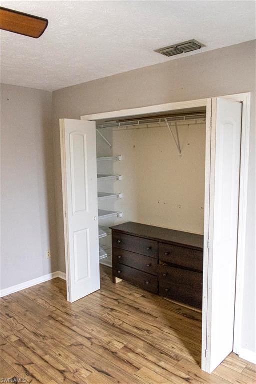 707 Hoover Dike Road Clewiston, FL 33440 - Photo 29 of 39 a view of walk in closet with wooden floor