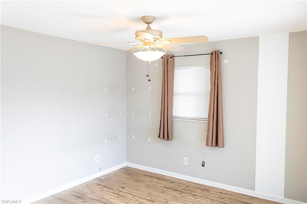 707 Hoover Dike Road Clewiston, FL 33440 - Photo 36 of 39 a view of a chandelier fan and wooden floor