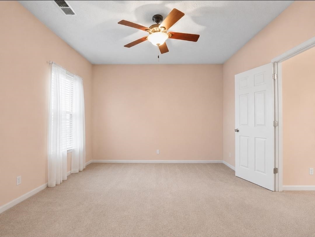 3779 Dancyville Road Stanton, TN 38069 - Photo 5 of 22 Carpeted room featuring a ceiling fan with integrated lighting, a window with blinds, and white trim
