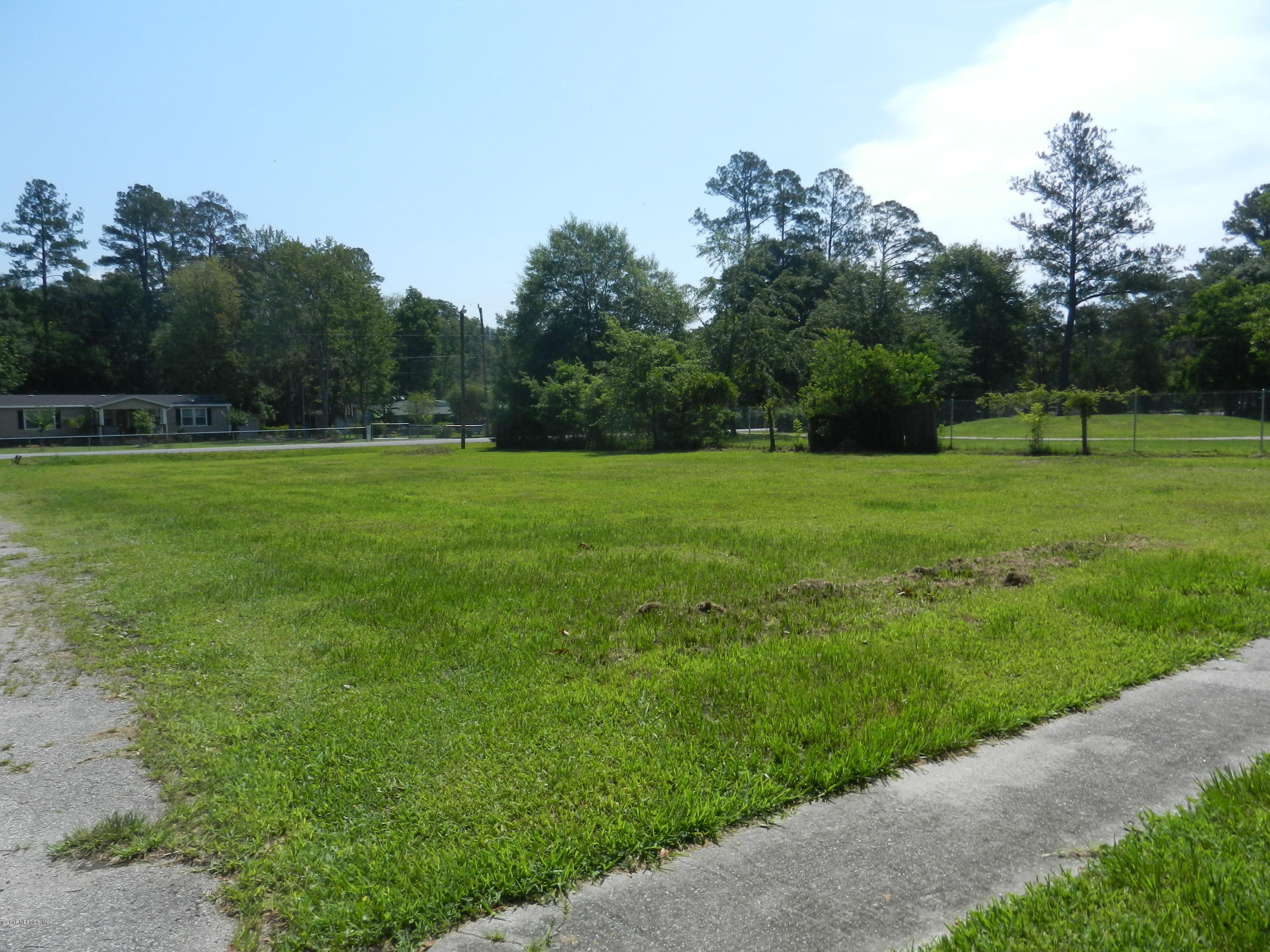 54537 Marlee Road Callahan, FL 32011 - Photo 17 of 17 a view of a grassy field with trees in the background