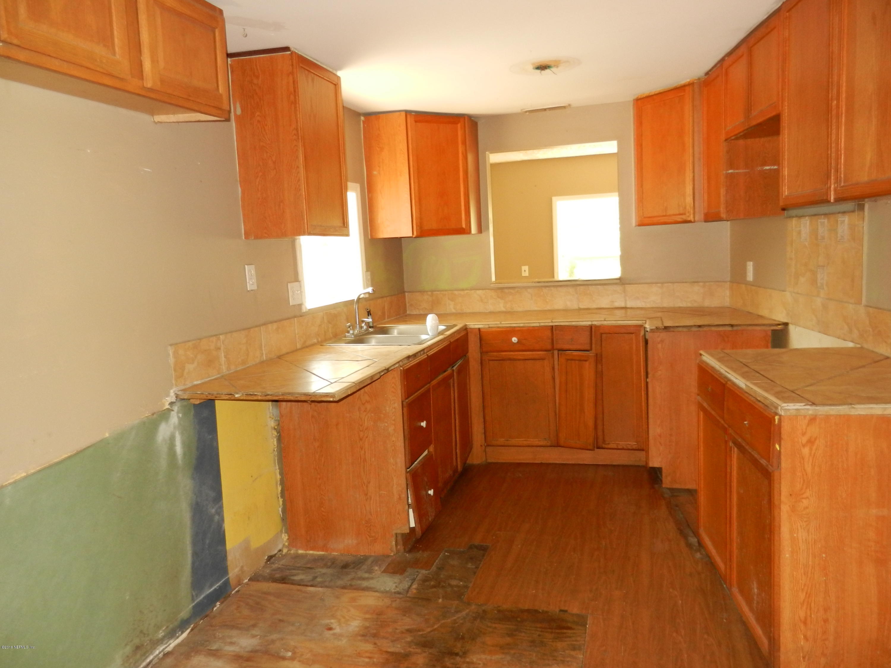 54537 Marlee Road Callahan, FL 32011 - Photo 5 of 17 a kitchen with stainless steel appliances a sink stove and cabinets