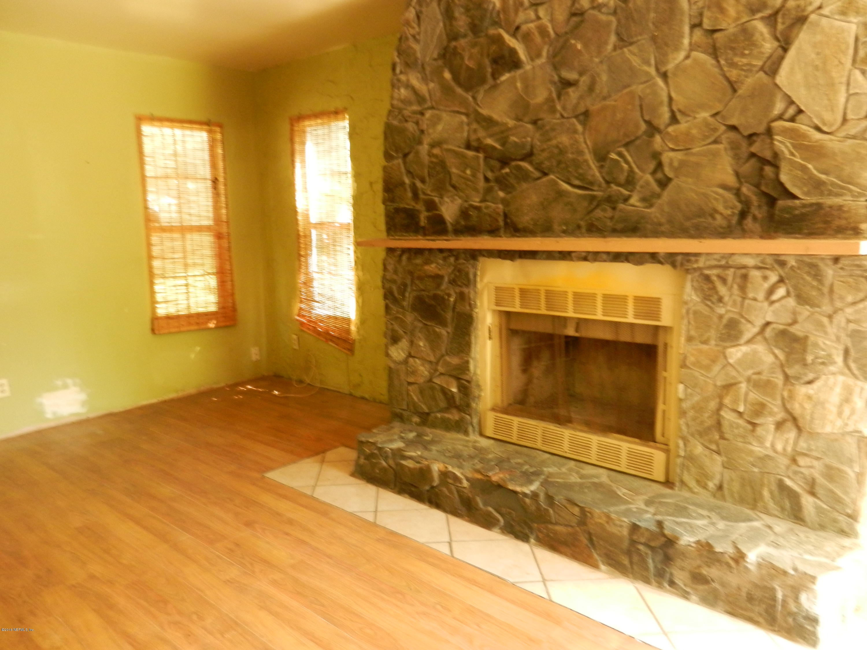 54537 Marlee Road Callahan, FL 32011 - Photo 8 of 17 a view of empty room with a fireplace and windows