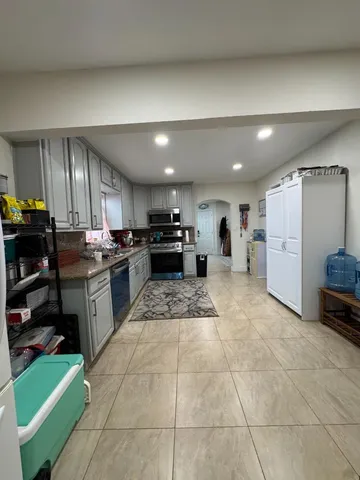 a kitchen with stainless steel appliances granite countertop a sink and cabinets