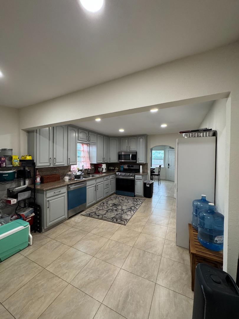 2712 Ferguson Road Gilroy, CA 95020 - Photo 36 of 60 a large white kitchen with a large window and stainless steel appliances