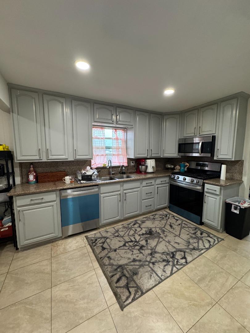 2712 Ferguson Road Gilroy, CA 95020 - Photo 37 of 60 a kitchen with stainless steel appliances granite countertop a stove sink and cabinets