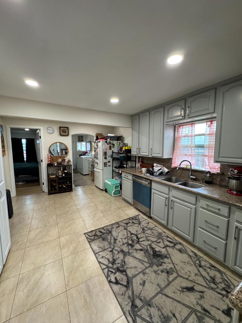 2712 Ferguson Road Gilroy, CA 95020 - Photo 40 of 60 a kitchen with stainless steel appliances granite countertop a stove sink and cabinets
