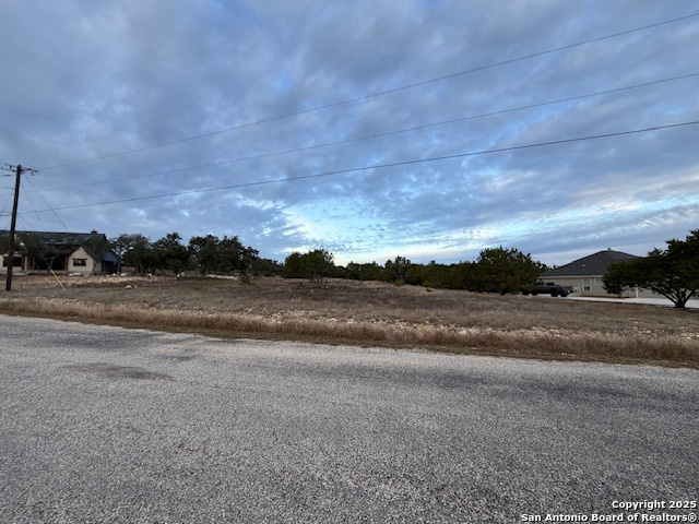160 Restless Wind Spring Branch, TX 78070 - Photo 10 of 17 a view of dirt yard with a car parked on the road