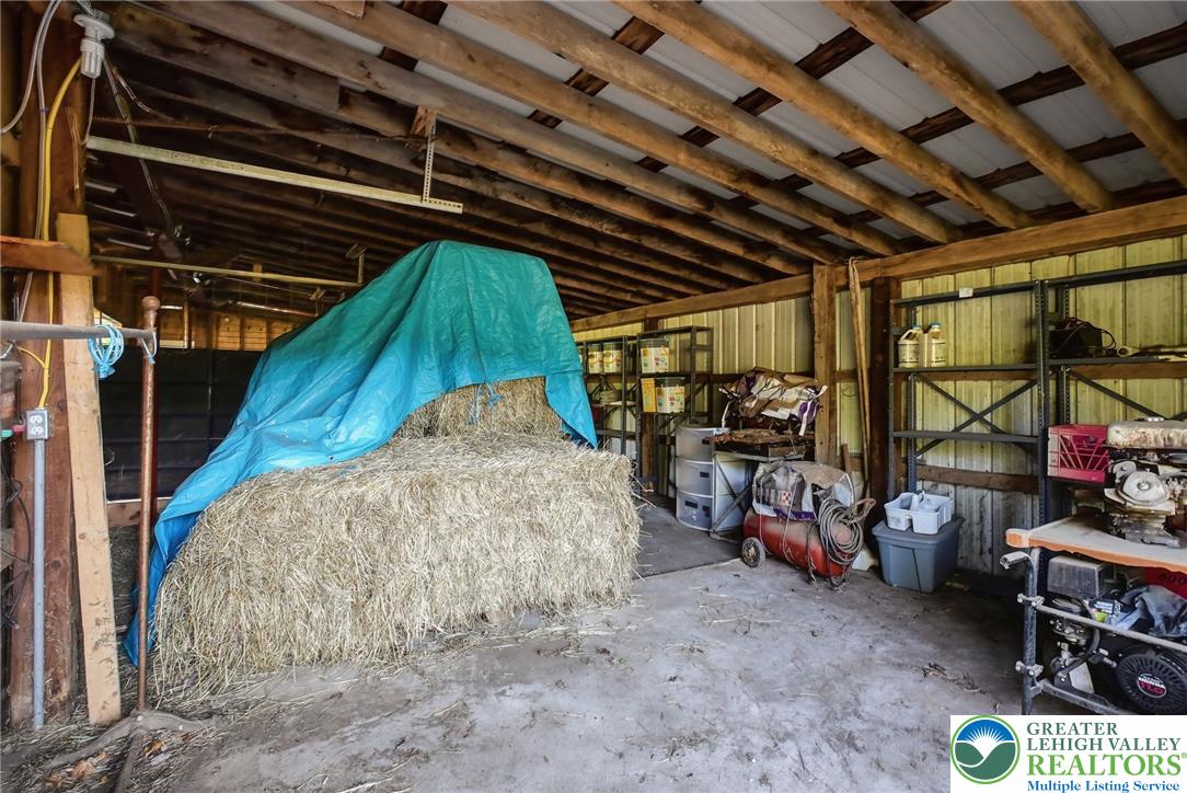 9033 Loop Road Slatington, PA 18080 - Photo 40 of 53 A rustic barn provides ample space for storage and equipment, with an exposed beam ceiling.