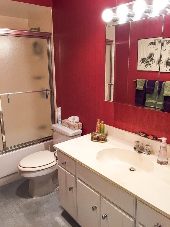77 Pond Avenue, Unit 606 Brookline, MA 02445 - Photo 15 of 19 a bathroom with a sink mirror vanity and toilet