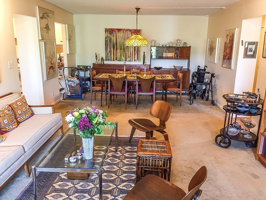 77 Pond Avenue, Unit 606 Brookline, MA 02445 - Photo 4 of 19 a living room filled with furniture and a chandelier