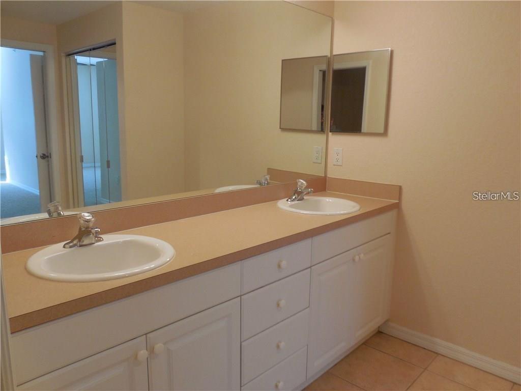 6405 Bay Cedar Lane, Unit 26 Bradenton, FL 34203 - Photo 11 of 19 a bathroom with a sink and a mirror