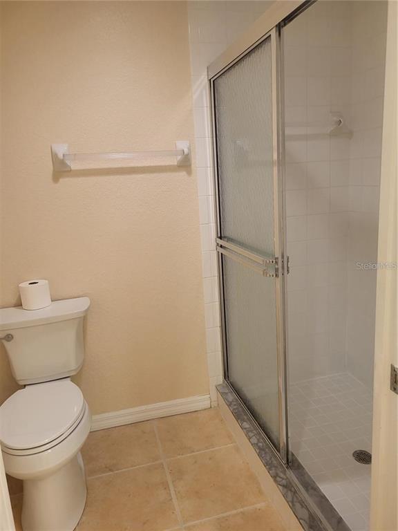 6405 Bay Cedar Lane, Unit 26 Bradenton, FL 34203 - Photo 12 of 19 a bathroom with a toilet and a shower