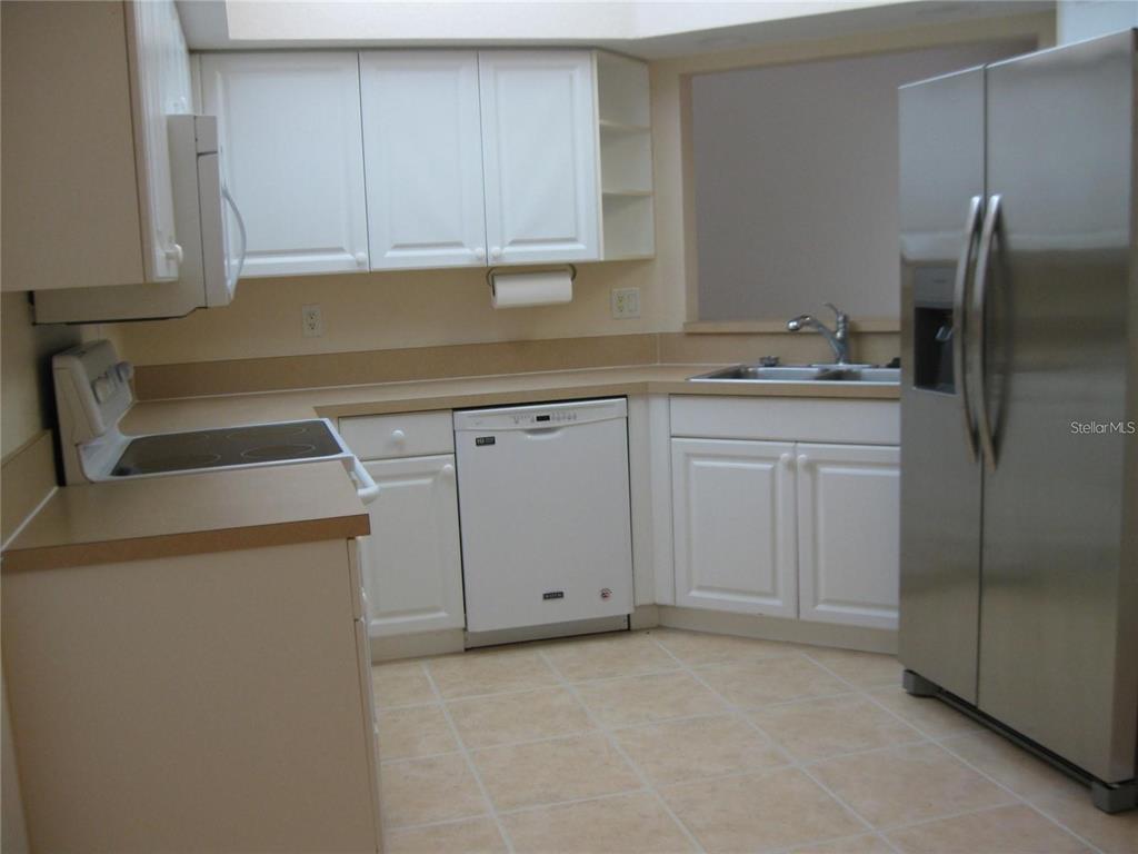 6405 Bay Cedar Lane, Unit 26 Bradenton, FL 34203 - Photo 3 of 19 a kitchen with a sink and cabinets