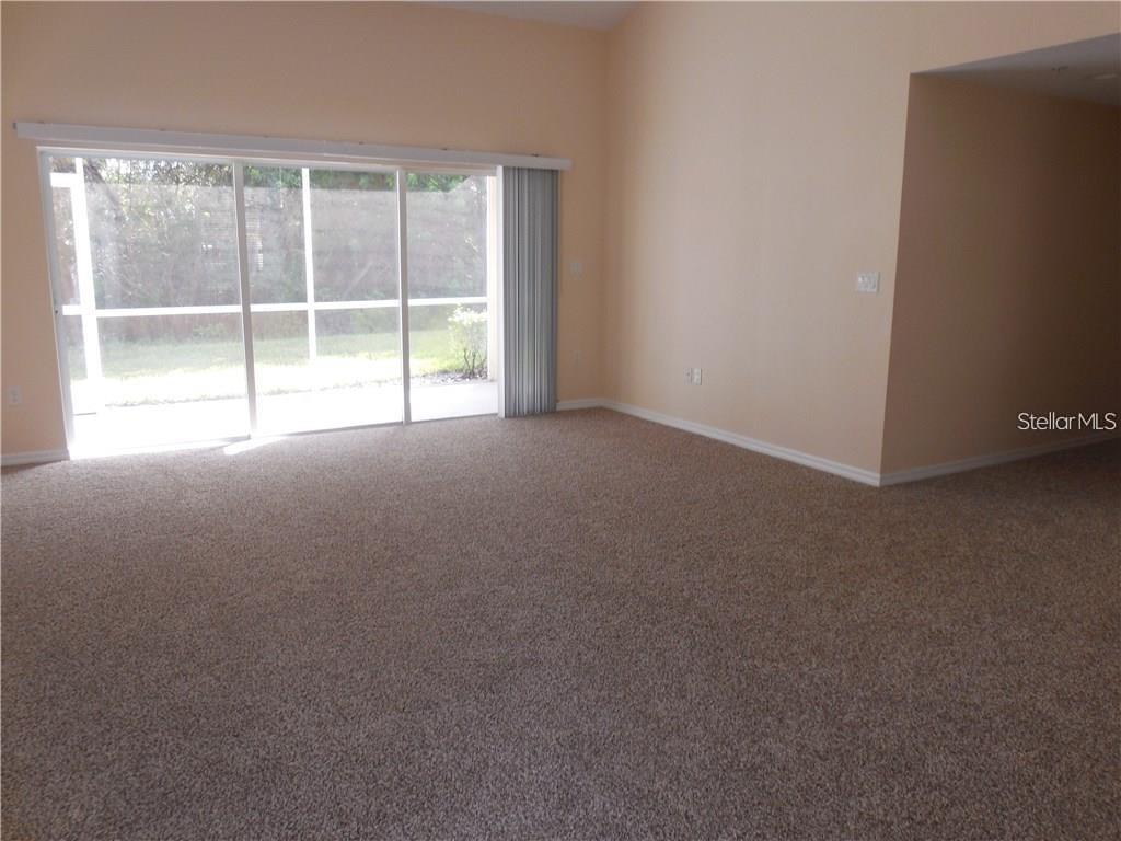 6405 Bay Cedar Lane, Unit 26 Bradenton, FL 34203 - Photo 9 of 19 a view of an empty room with a window